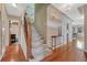 Entryway with hardwood floors, a carpeted staircase, and a view to the living room at 1590 S Milwaukee St, Denver, CO 80210