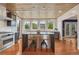 Bright kitchen with wooden ceiling, stainless appliances, center island, and hardwood floors at 1590 S Milwaukee St, Denver, CO 80210