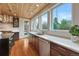 Modern kitchen with white countertops, wooden ceiling, stainless steel appliances, and hardwood floors at 1590 S Milwaukee St, Denver, CO 80210