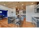 Open kitchen with wooden ceiling, center island, stainless steel appliances, built-in desk and hardwood floors at 1590 S Milwaukee St, Denver, CO 80210