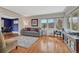 Bright living room with hardwood floors, a large window, a gray couch, and neutral decor at 1590 S Milwaukee St, Denver, CO 80210