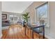 Living room with hardwood floors, neutral colors, and a view to a formal dining table and chairs at 1590 S Milwaukee St, Denver, CO 80210