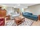 Cozy living room features a sitting area with couches and wood coffee table on top of an area rug at 1590 S Milwaukee St, Denver, CO 80210