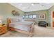 Bright main bedroom featuring a ceiling fan, comfortable seating, and ample natural light at 1590 S Milwaukee St, Denver, CO 80210