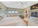 Spacious bedroom featuring a fireplace and a view of a small office, for convenience at 1590 S Milwaukee St, Denver, CO 80210