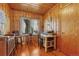 Charming home office with wood paneling, hardwood floors, vintage furniture, and natural light at 1590 S Milwaukee St, Denver, CO 80210