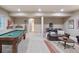 This finished basement features a pool table, lounge area, and entertainment setup, great for entertaining guests at 817 Uinta Way, Denver, CO 80230