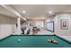 The finished basement boasts a pool table, wet bar, and lounge area for entertaining guests at 817 Uinta Way, Denver, CO 80230