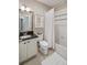 The cozy bathroom has a shower over the tub, toilet, vanity, and a framed mirror with built-in storage at 817 Uinta Way, Denver, CO 80230
