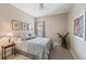 This quaint bedroom is furnished with a bed, ceiling fan, and side table with charming decorations at 817 Uinta Way, Denver, CO 80230