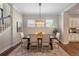 Cozy dining room with a wooden table, seating for six, and an elegant light fixture at 817 Uinta Way, Denver, CO 80230