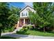 Charming home with brick accents, inviting front porch, and well-maintained landscaping at 817 Uinta Way, Denver, CO 80230