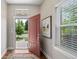 Bright foyer with hardwood floors, a red door, and stylish decor at 817 Uinta Way, Denver, CO 80230