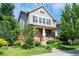 Charming two-story home featuring manicured lawn, brick accents, and inviting front porch at 817 Uinta Way, Denver, CO 80230