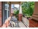 Inviting front porch featuring cozy seating area with chair and pillow at 817 Uinta Way, Denver, CO 80230