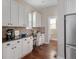 Bright kitchen area with white cabinets, granite countertops, and a built-in desk space at 817 Uinta Way, Denver, CO 80230