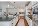 Open kitchen featuring stainless steel appliances, granite countertops, and a large island with bar seating at 817 Uinta Way, Denver, CO 80230