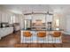 Open kitchen featuring a large island with barstool seating and modern stainless steel appliances at 817 Uinta Way, Denver, CO 80230