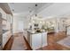Open kitchen showcasing large island, modern appliances, and seamless flow to the living area at 817 Uinta Way, Denver, CO 80230