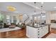 Open-concept kitchen and living room with modern lighting and a large sectional at 817 Uinta Way, Denver, CO 80230