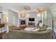Cozy living room featuring a fireplace, large sectional, and abundant natural light at 817 Uinta Way, Denver, CO 80230