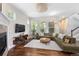 Bright living room with fireplace, large windows, and plush sectional sofa at 817 Uinta Way, Denver, CO 80230