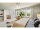 The bright main bedroom has multiple windows with views, a ceiling fan, and an ensuite bathroom at 817 Uinta Way, Denver, CO 80230