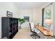 Bright office space with hardwood desk, white chair and modern shelving at 817 Uinta Way, Denver, CO 80230