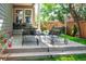 Back patio with lounge seating, bistro set, and mature landscaping for outdoor relaxation at 817 Uinta Way, Denver, CO 80230