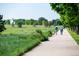 Scenic walking path with mature trees and grassy fields, perfect for an active lifestyle at 817 Uinta Way, Denver, CO 80230