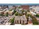 Aerial view of brick apartment building with urban area at 1100 N Grant St # 208, Denver, CO 80203