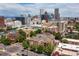 Aerial view of brick apartment building featuring Denver skyline at 1100 N Grant St # 208, Denver, CO 80203