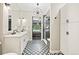 Bathroom featuring a double vanity, an elegant chandelier and a walk-in shower at 1100 N Grant St # 208, Denver, CO 80203