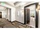 Hallway view leading into a condo showcasing modern lighting, carpeted floors, and an open doorway at 1100 N Grant St # 208, Denver, CO 80203