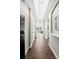 Bright hallway leading to the living area features hardwood floors, recessed lighting, and neutral paint at 1100 N Grant St # 208, Denver, CO 80203