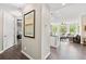 Inviting living area with hardwood floors, recessed lights, and neutral walls is partially visible from the hallway at 1100 N Grant St # 208, Denver, CO 80203