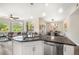 Open concept living space with stainless steel appliances and dining area at 1100 N Grant St # 208, Denver, CO 80203