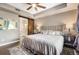 Large main bedroom features ensuite bathroom with barn door, neutral tones, and ceiling fan at 1100 N Grant St # 208, Denver, CO 80203