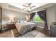 Comfortable main bedroom with neutral tones, ceiling fan, and large window at 1100 N Grant St # 208, Denver, CO 80203