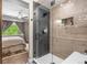 Walk-in shower featuring a niche and elegant glass door, adjacent to the primary bedroom at 1100 N Grant St # 208, Denver, CO 80203