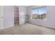 Bedroom with a large window, closet, and soft carpet creating a comfortable living space at 5552 Flanders Way, Denver, CO 80249