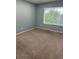 Bedroom with a window and neutral carpet at 5552 Flanders Way, Denver, CO 80249