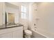 Clean bathroom with white tile, bathtub, and vanity with dark countertop at 261 Paloma Way, Elizabeth, CO 80107