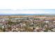 Expansive aerial view of the neighborhood with distant mountain backdrop and nearby lake at 134 N 6Th Ave, Brighton, CO 80601