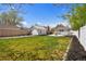 Open backyard featuring a large green lawn area, firepit, and privacy fence at 134 N 6Th Ave, Brighton, CO 80601