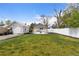 Large backyard area featuring a green lawn, white rock fire pit, and perimeter privacy fencing at 134 N 6Th Ave, Brighton, CO 80601