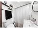 Compact bathroom featuring a shower with curtain, toilet and vanity sink at 134 N 6Th Ave, Brighton, CO 80601