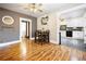 Dining room with hardwood floors, with a dark wooden dining table and view into the kitchen at 134 N 6Th Ave, Brighton, CO 80601