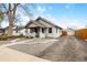 Charming single Gathering home with a front porch and gravel driveway and landscaping at 134 N 6Th Ave, Brighton, CO 80601