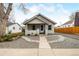 Charming single Gathering home with a front porch, gravel driveway, and rock landscaping at 134 N 6Th Ave, Brighton, CO 80601